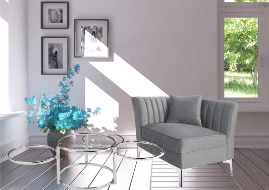 Contemporary grey velvet chaise lounge with decorative stitching and matching pillow
