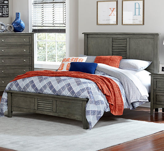 Gray wooden platform bed with louvered headboard and diamondpatterned bedding