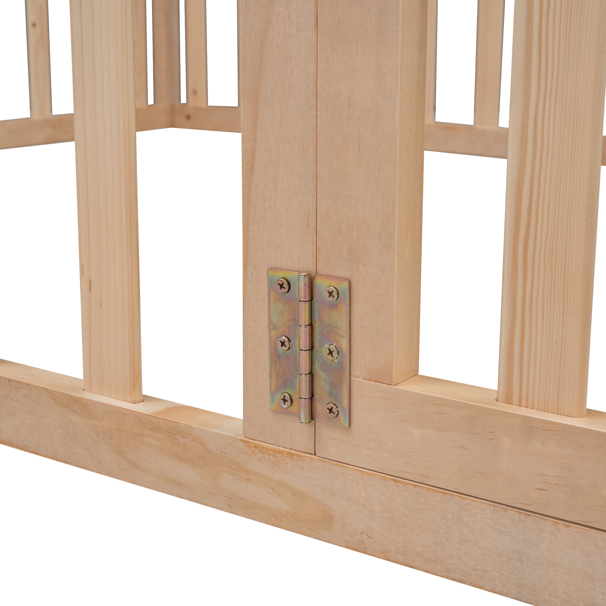 Closeup of a brass door hinge with screws on unfinished wooden crib frame