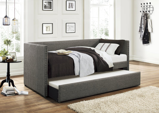 Gray fabric daybed with nailhead trim and trundle pulled out