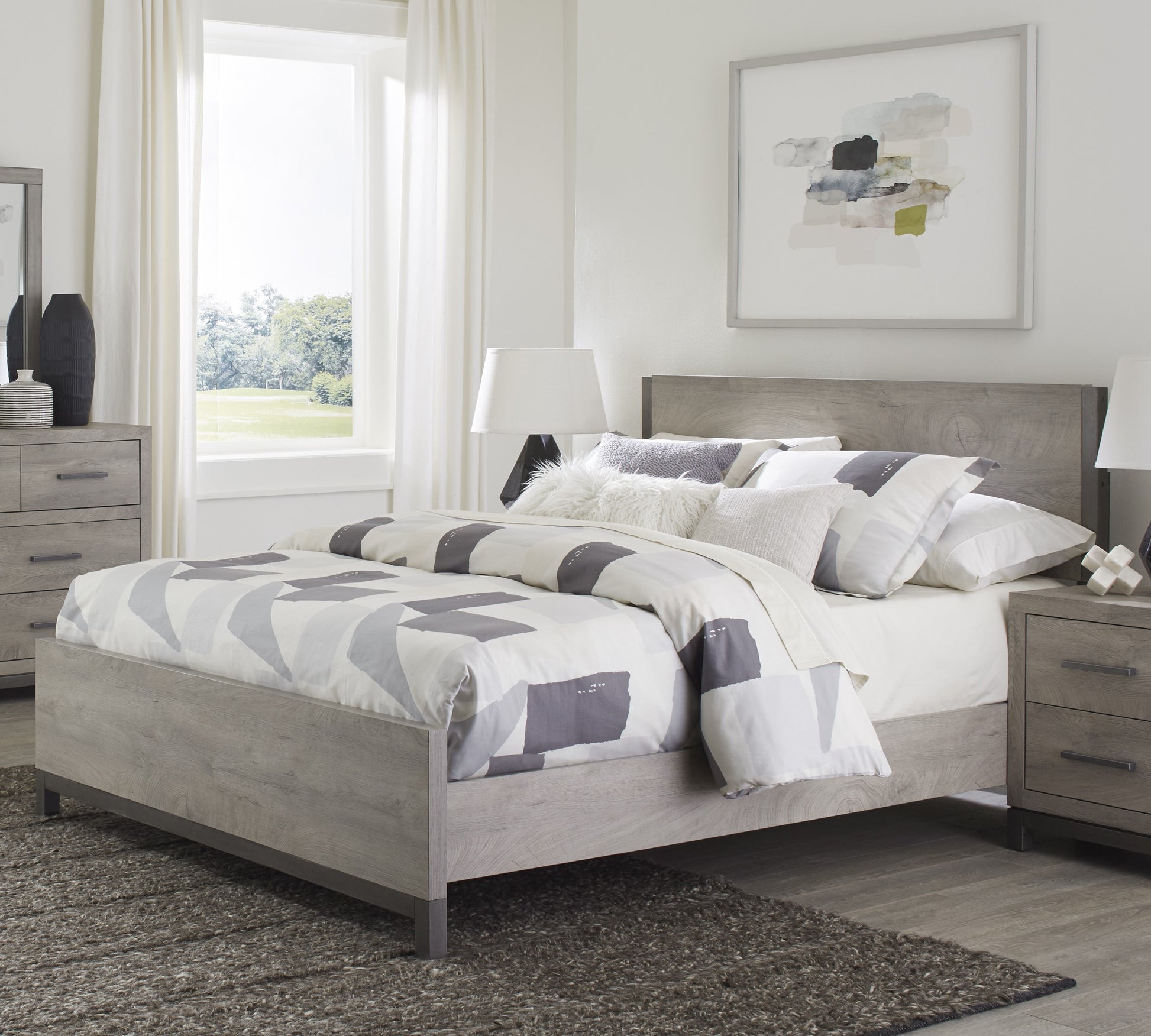 Grey wood platform bed frame with modern geometric bedding Perfect for a bedroom