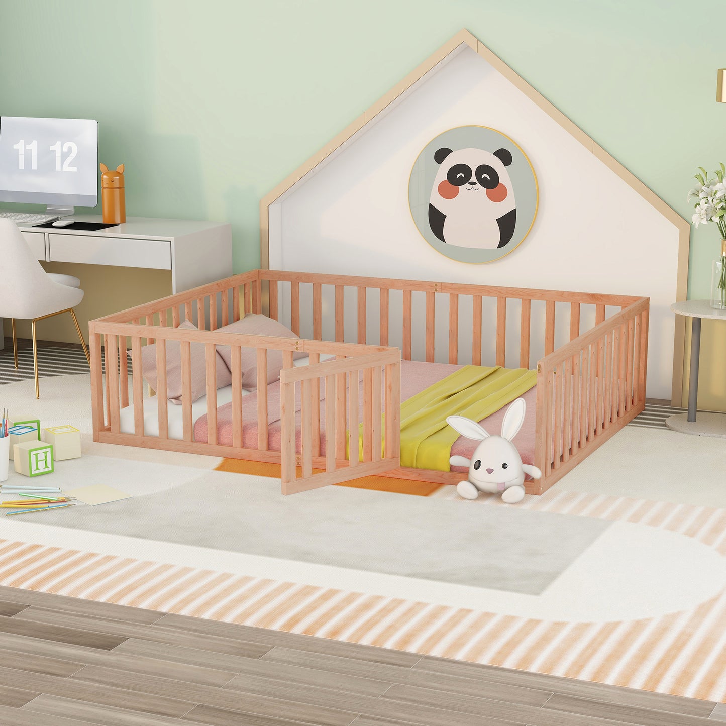 Wooden toddler bed with gate and pink bedding
