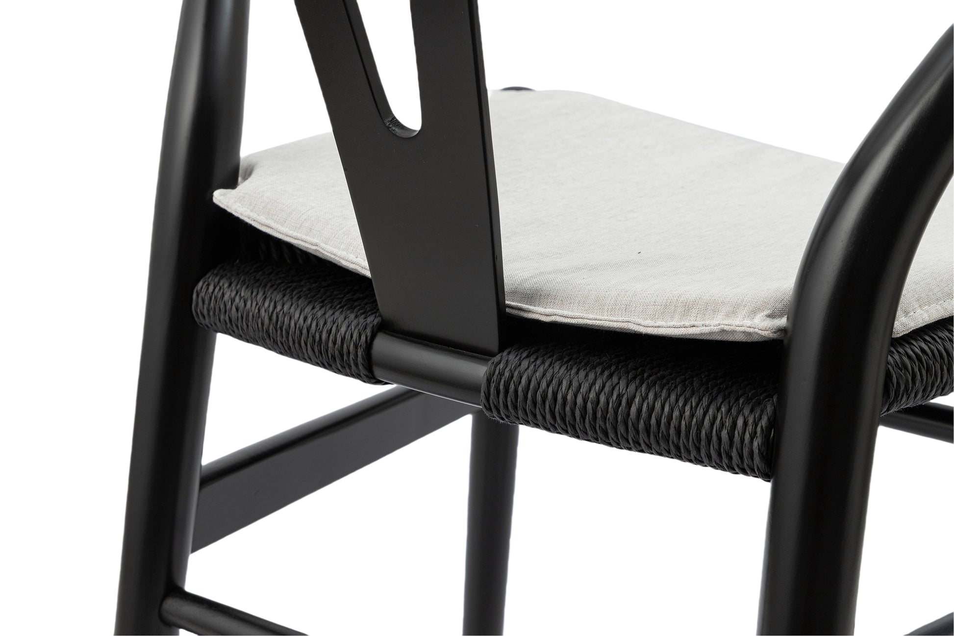 Black metal dining chair with light beige linen cushion and woven rope seat
