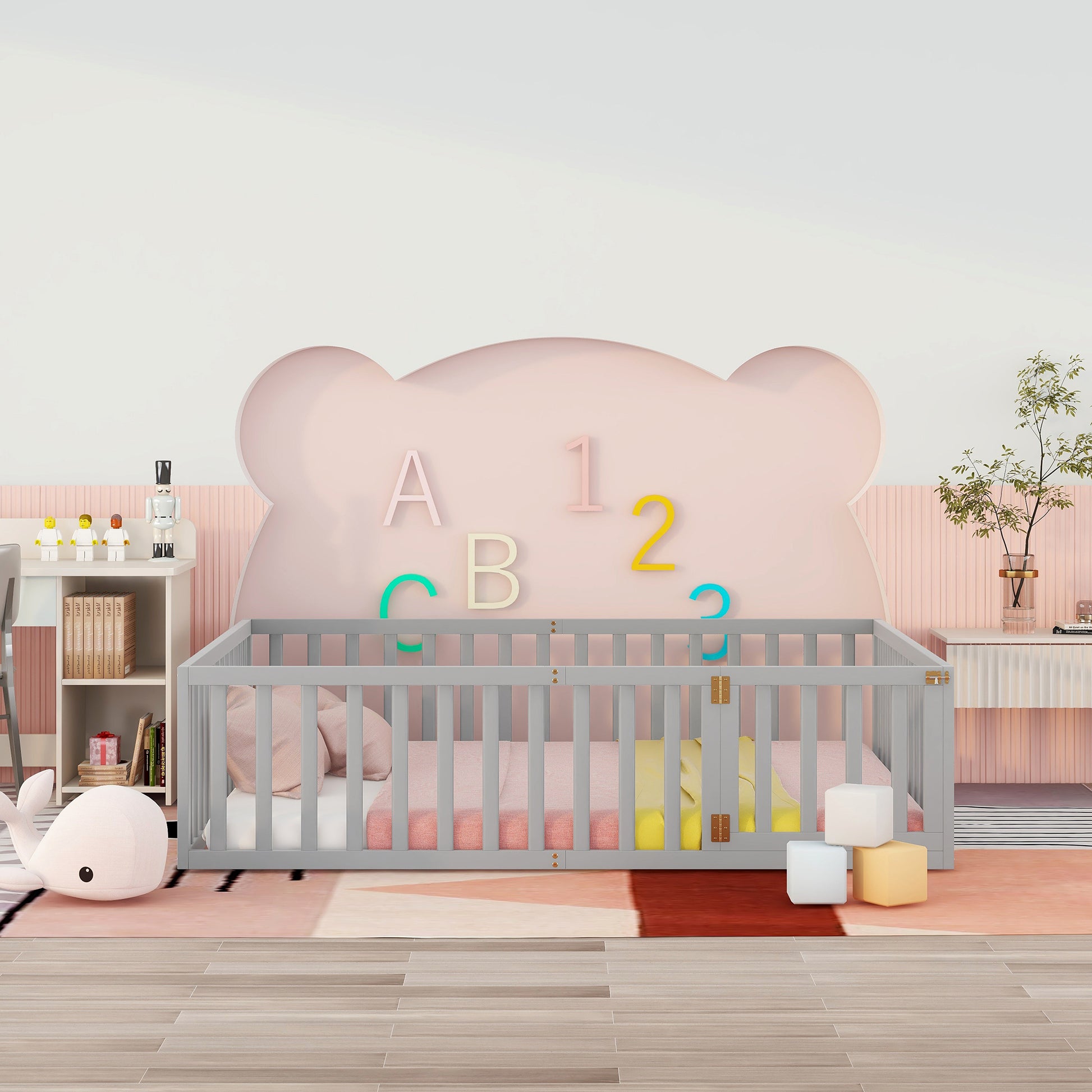 Gray wooden baby crib with pink bedding and whale toy
