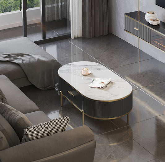 Oval marble coffee table with fluted dark grey base and gold accents perfect for modern living rooms