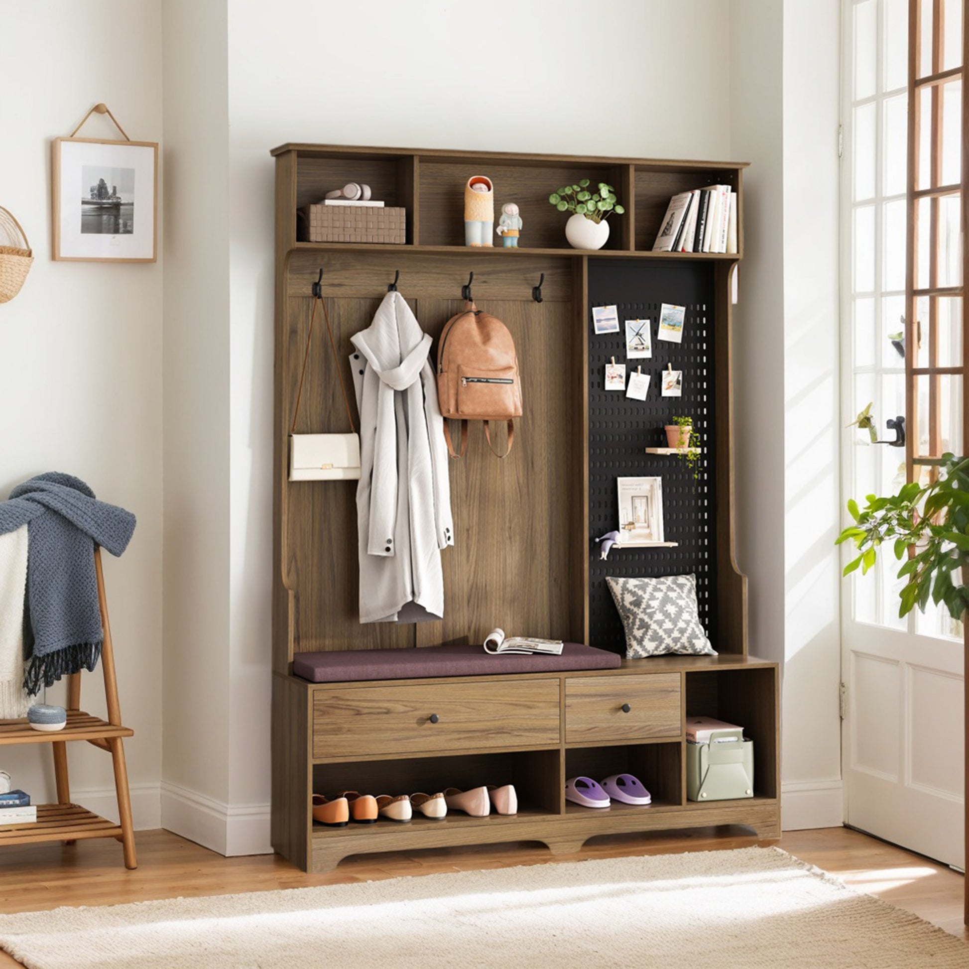 Wooden hall tree with dark brown finish featuring coat hooks a bench seat and shoe storage below for entryway organization