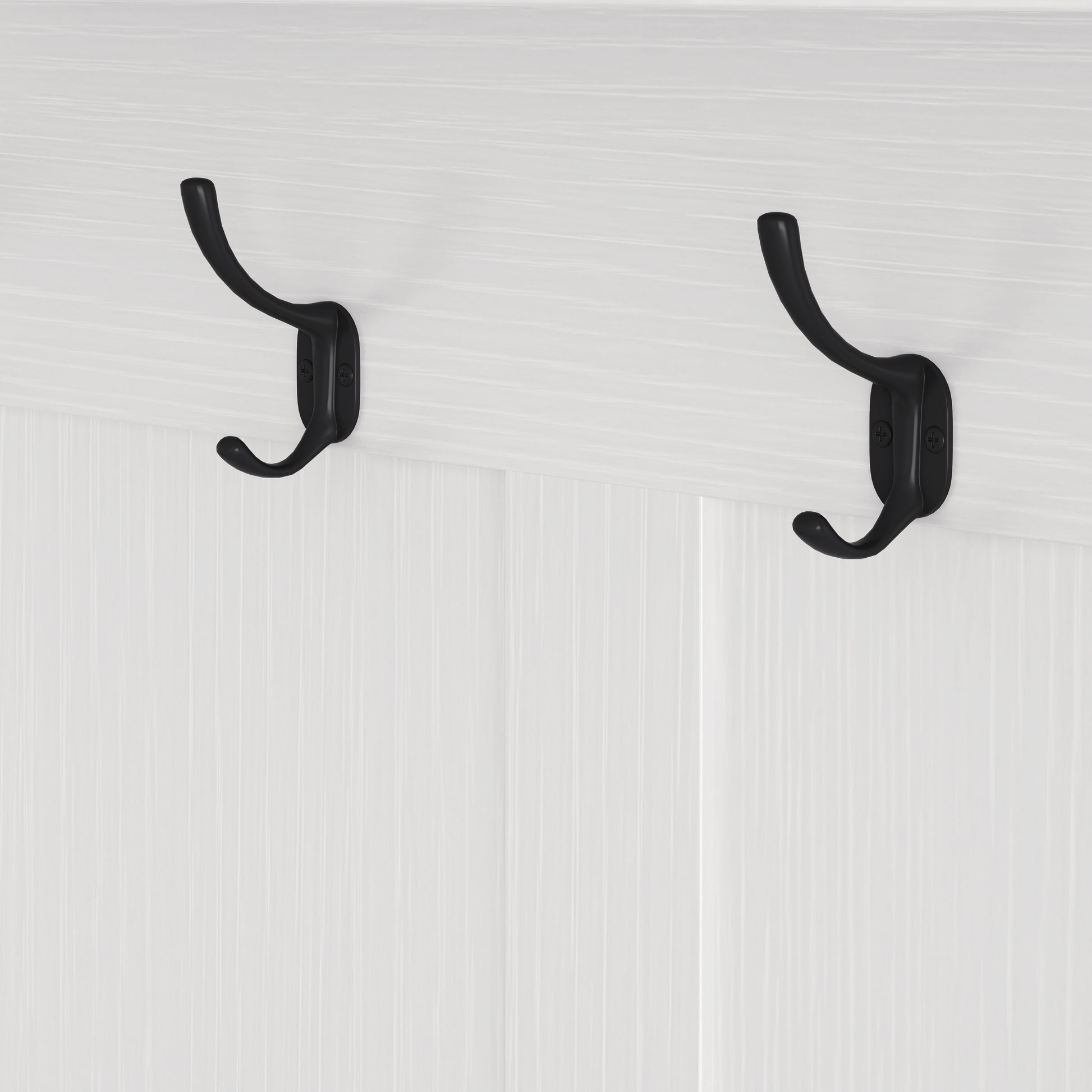 Classic black metal double coat hooks on a white beadboard background