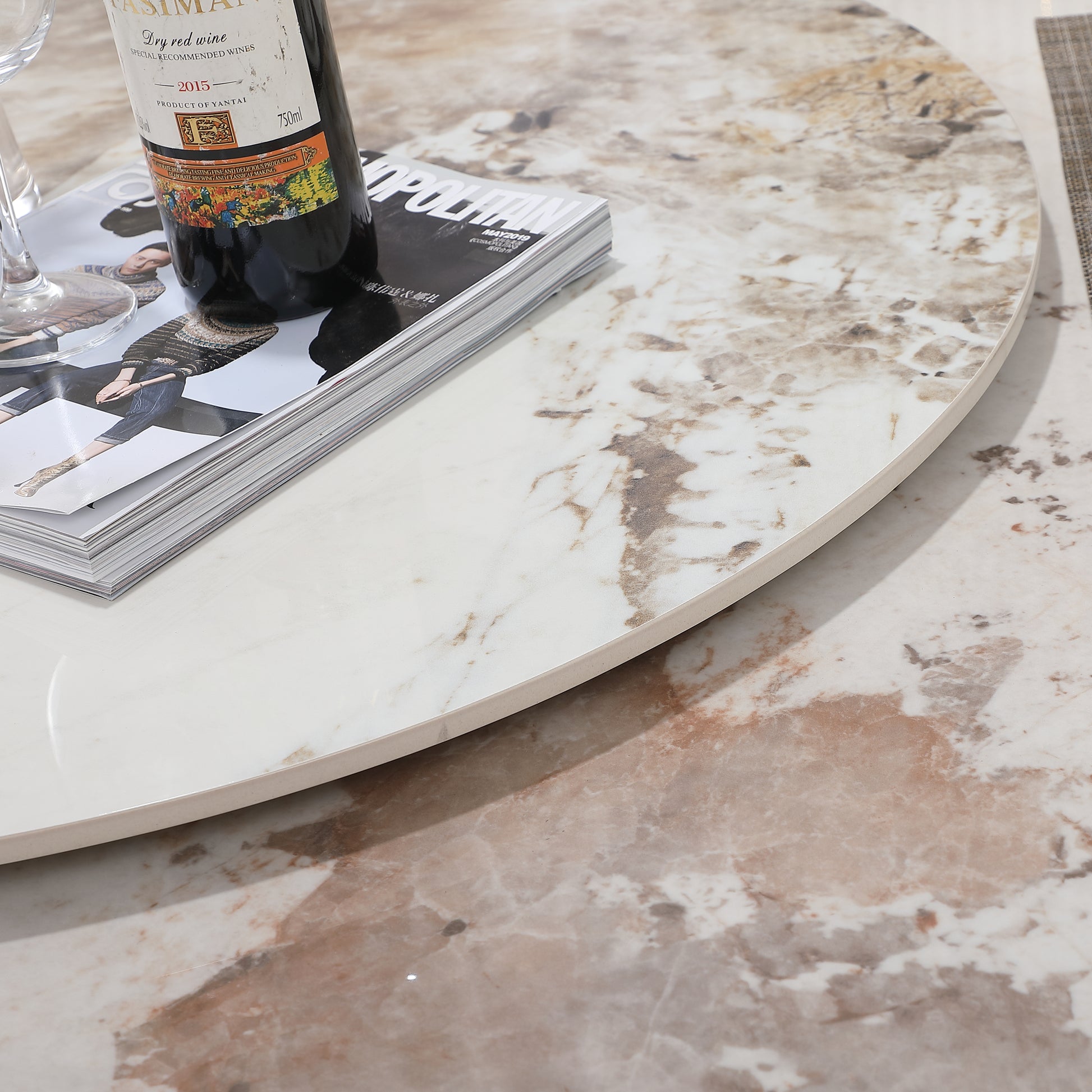 Round marble coffee table with wine bottle and magazine
