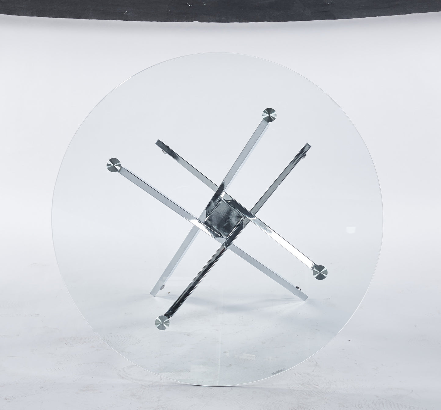 Round glass coffee table with chrome starburst base