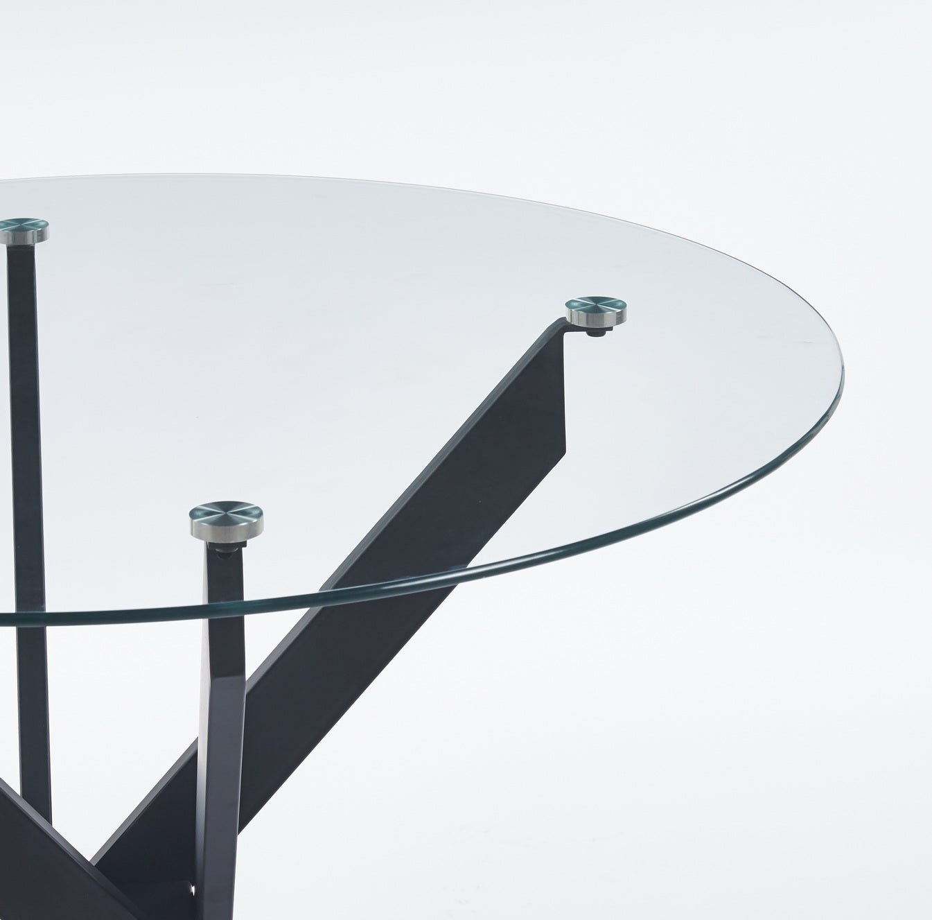 Round glass coffee table with sleek black metal base