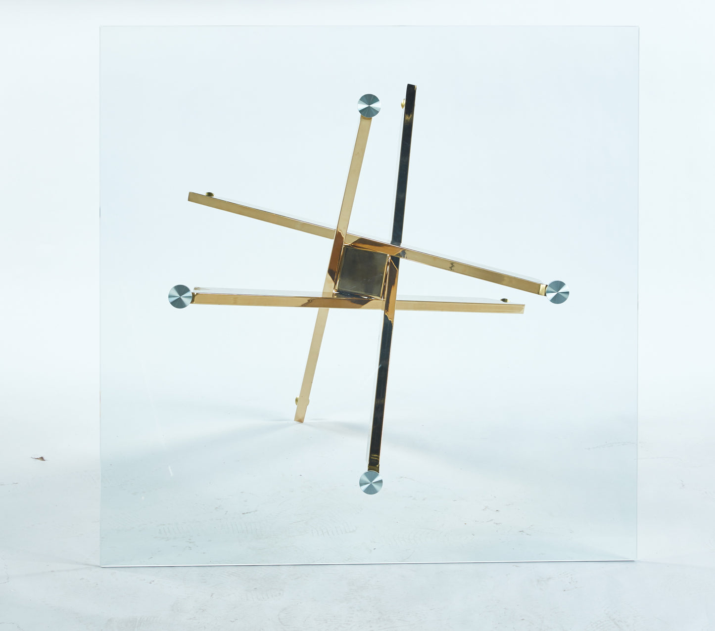 Modern glass coffee table with geometric gold metal base