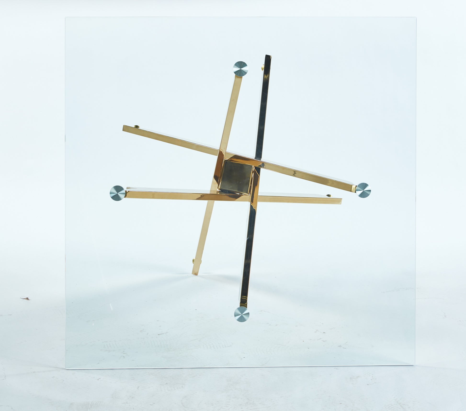 Modern glass coffee table with geometric gold metal base