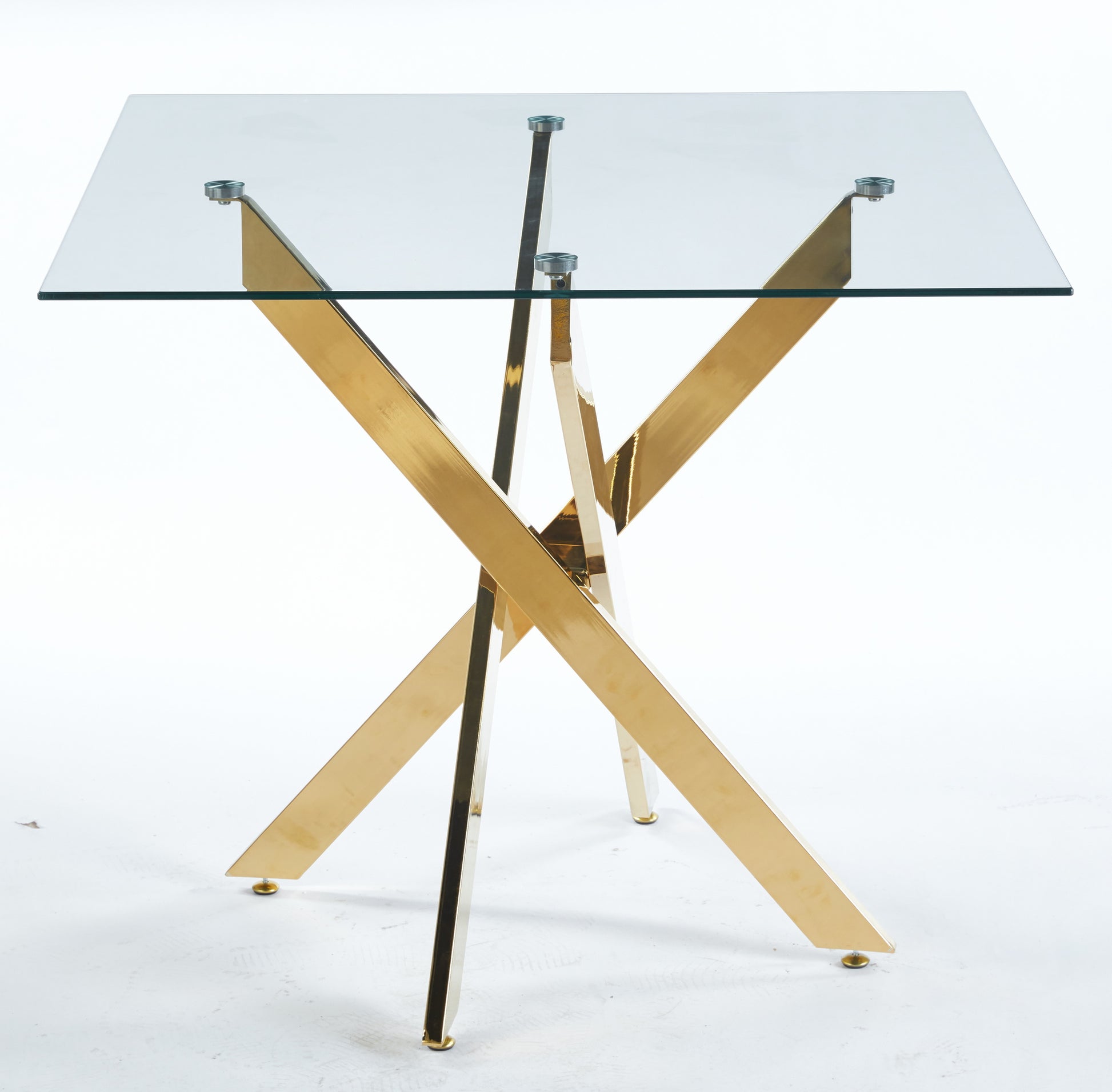 Modern glass dining table with a striking gold crossleg base