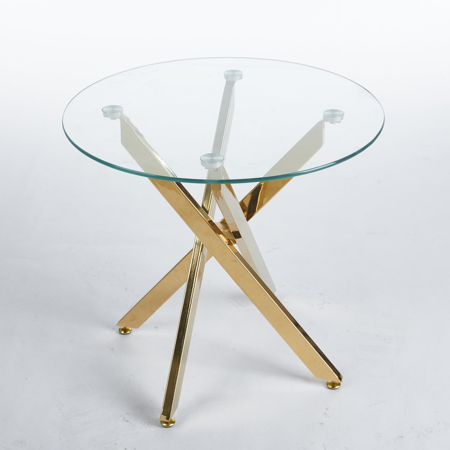Round glasstop side table with gold crisscross metal legs