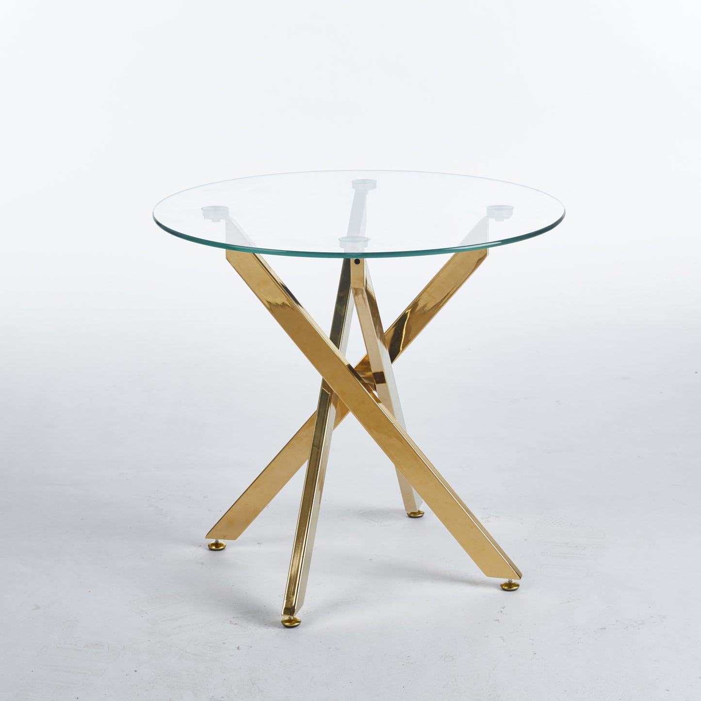 Round glass top accent table with polished gold geometric base