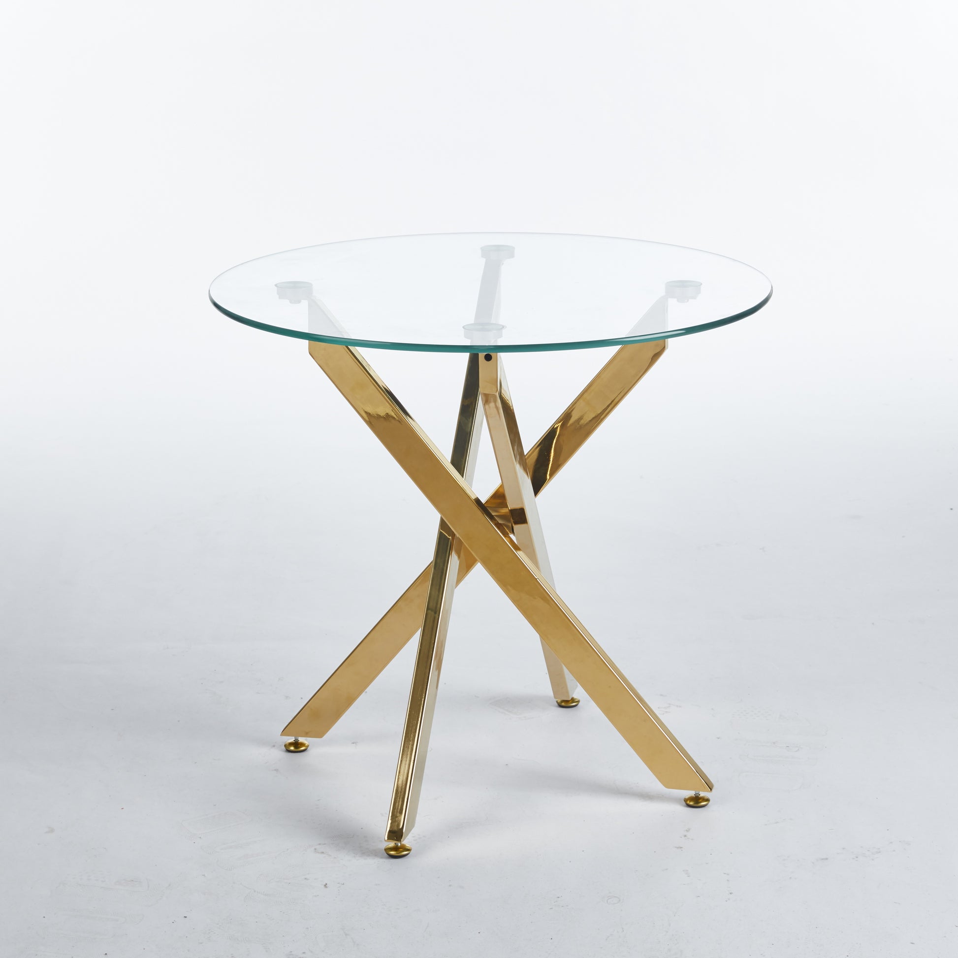 Round glass top accent table with polished gold geometric base