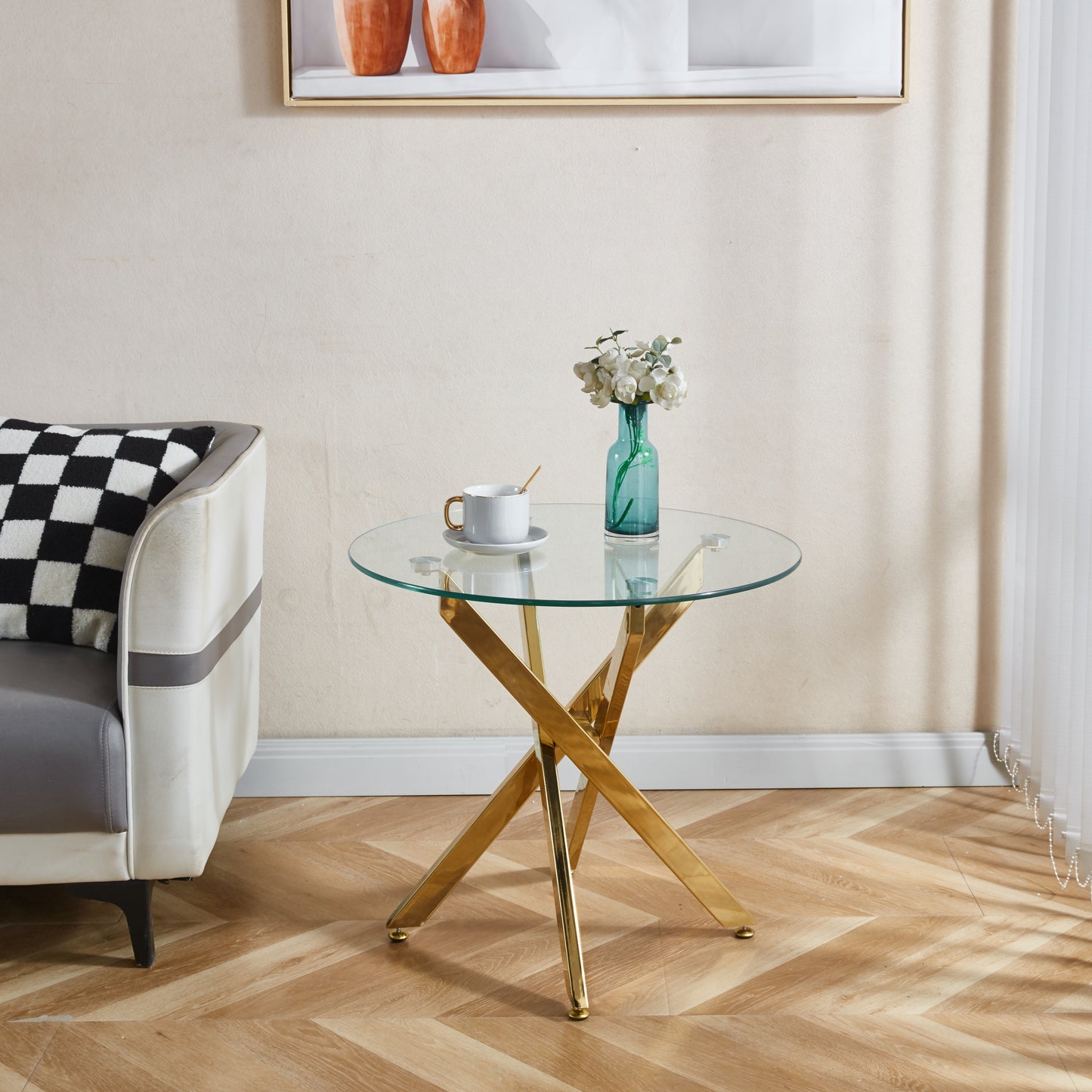Round glass coffee table with gold Xshaped base