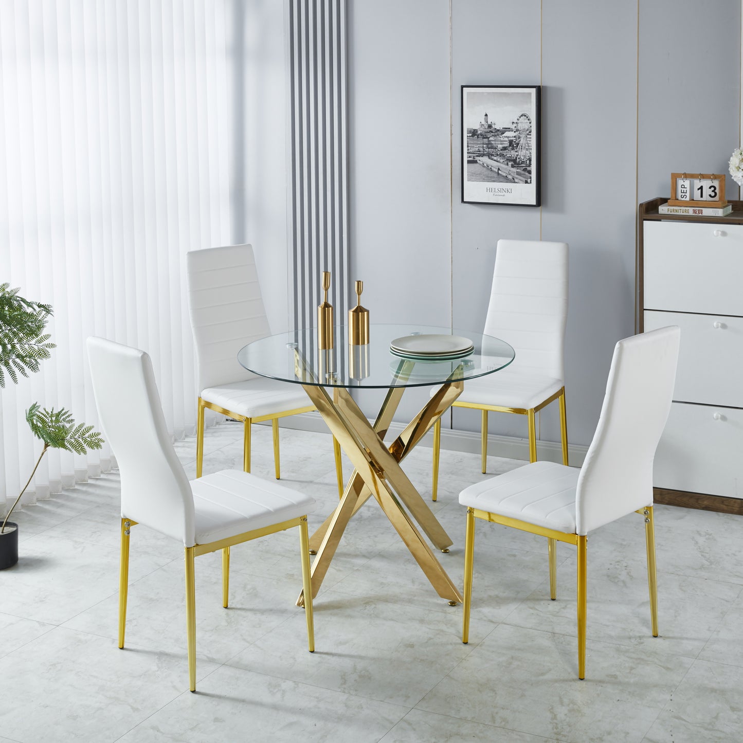 White upholstered dining chairs with gold legs around a glasstop table