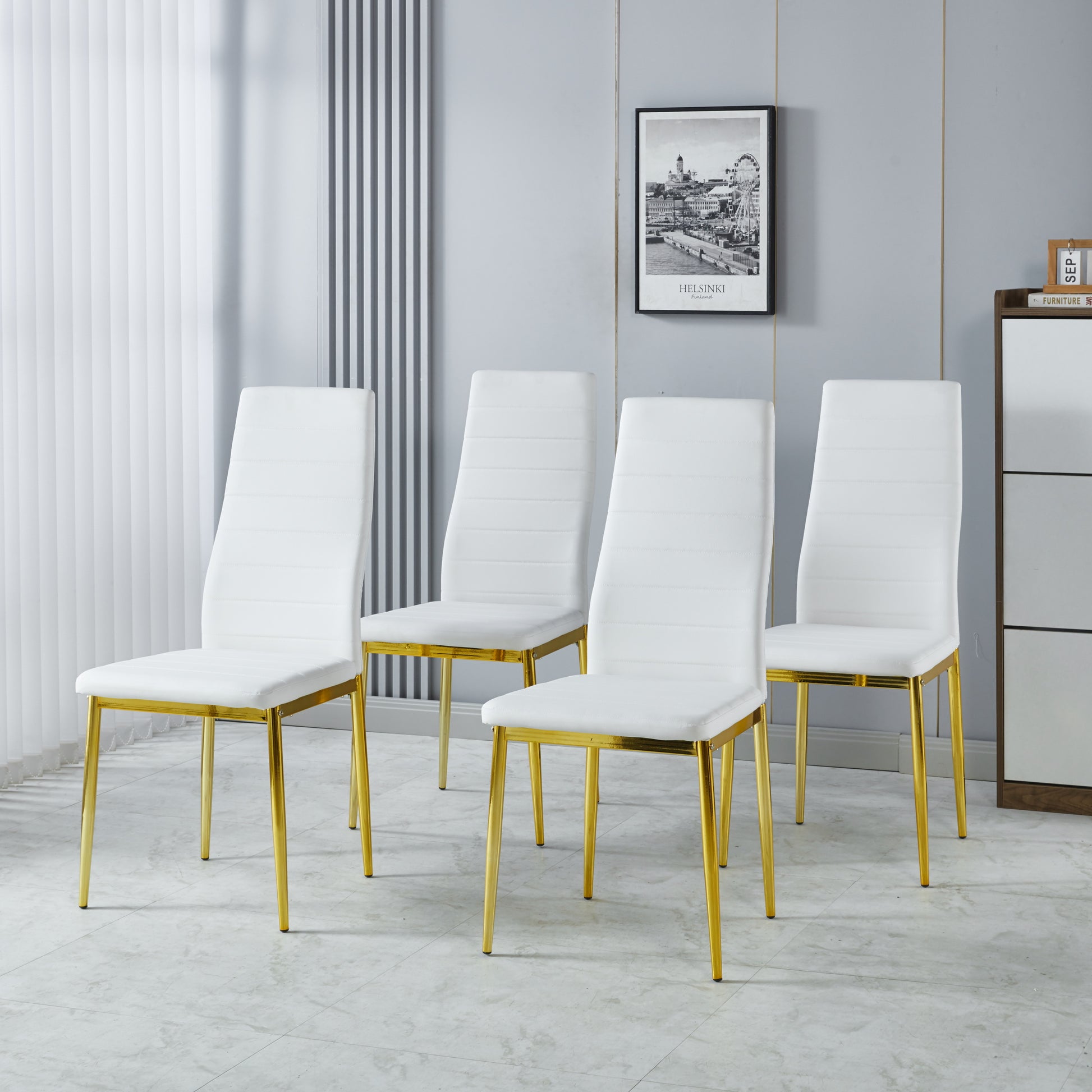 Set of four white faux leather dining chairs with gold metal legs