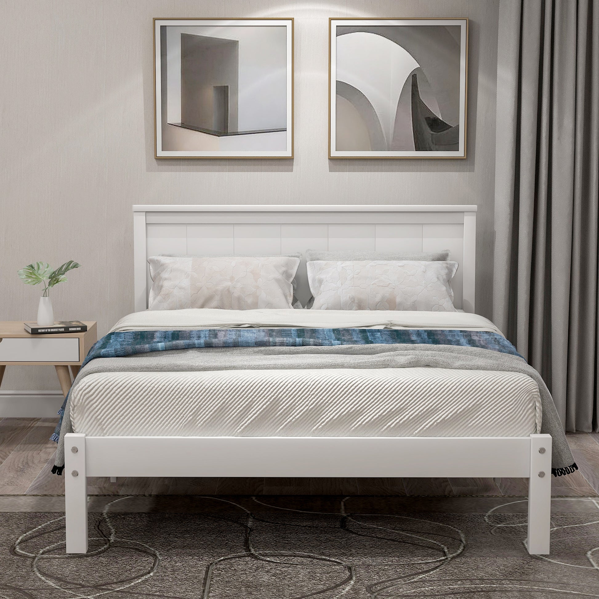 White wooden platform bed frame with tufted headboard and plush bedding