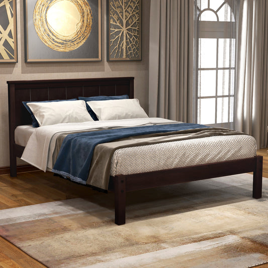 Dark wood queen bed frame with upholstered headboard and layered bedding in blue and cream