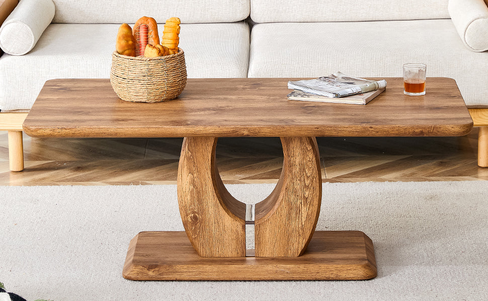 Wooden coffee table with carved curved legs and a rustic finish