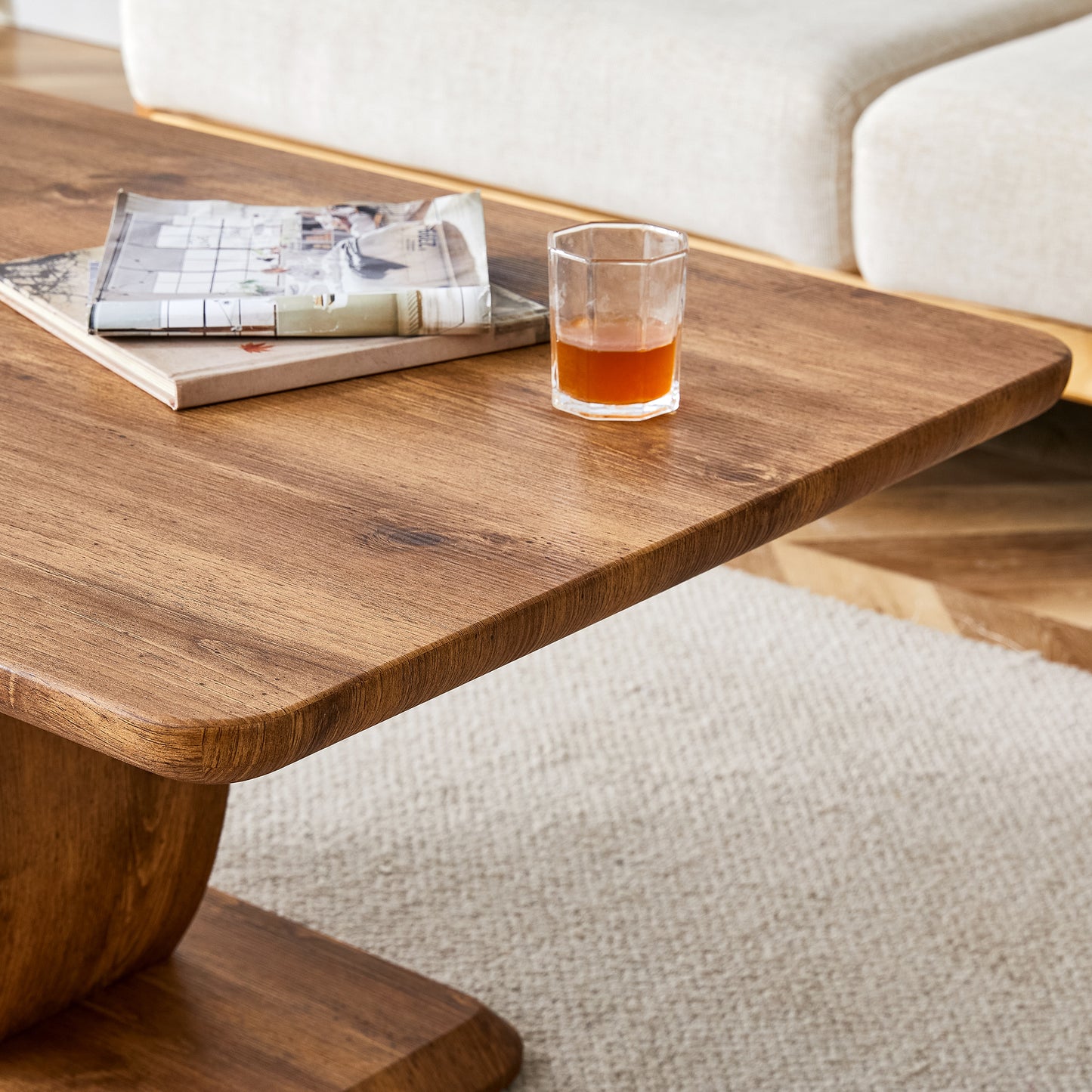 Rustic wood coffee table with a curved pedestal base