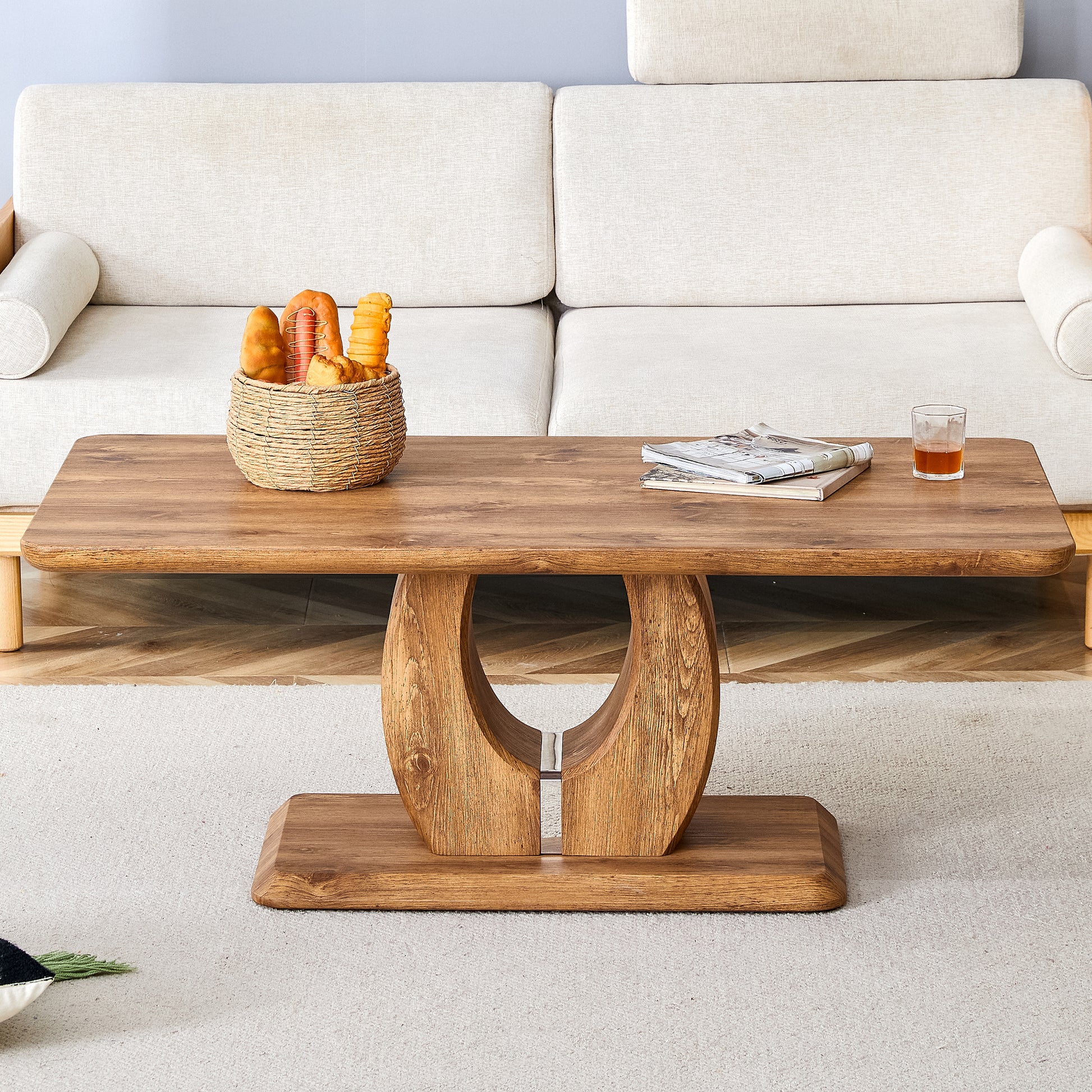 Solid wood coffee table with carved pedestal base