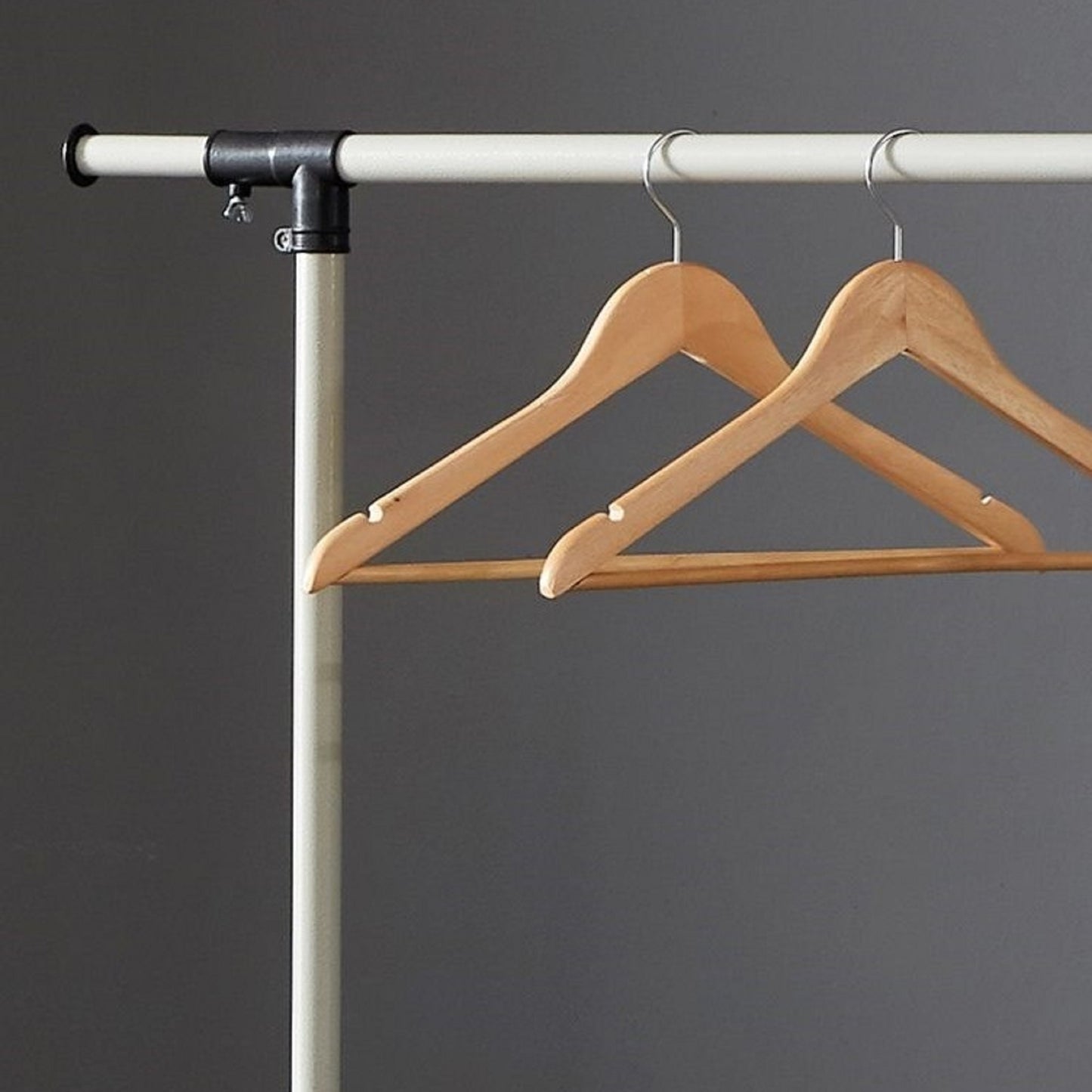 Natural wood hangers with notches on a clothing rack