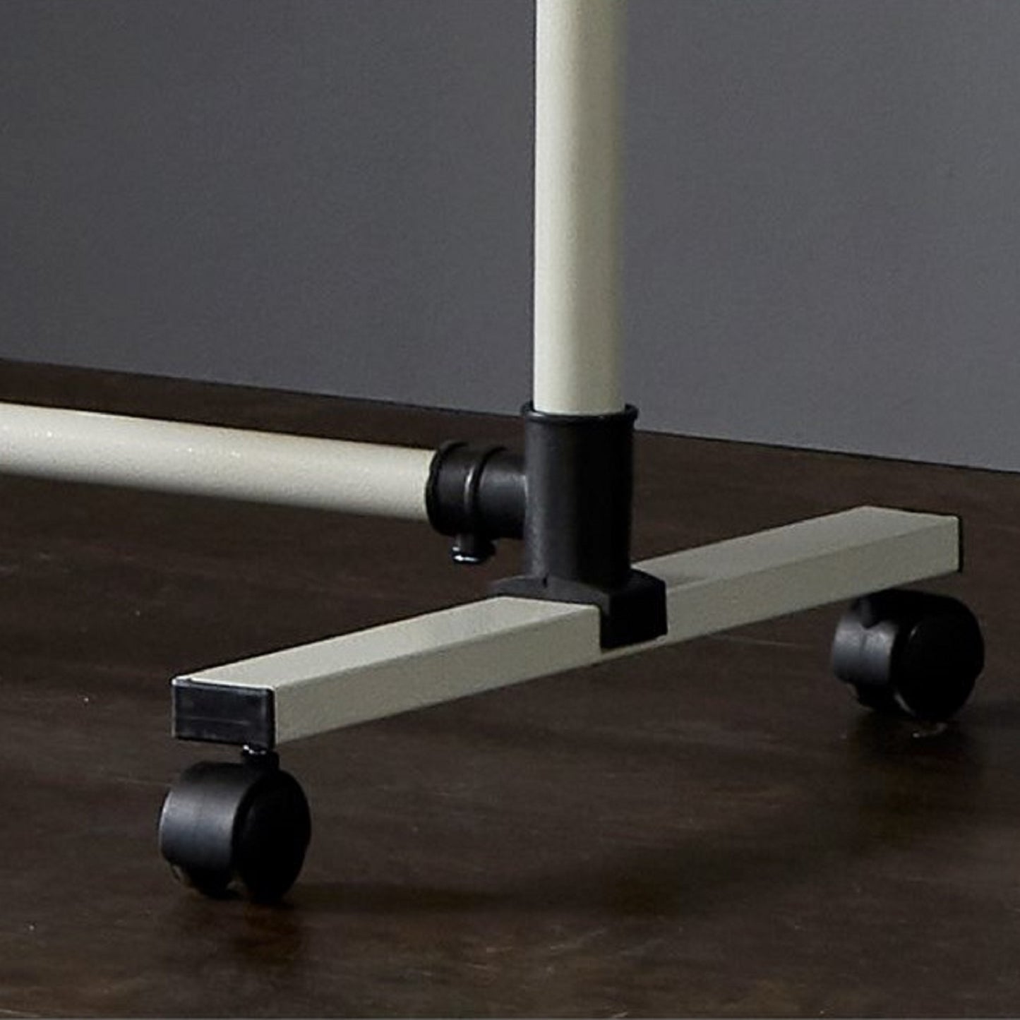 Cream metal garment rack base with black swivel casters