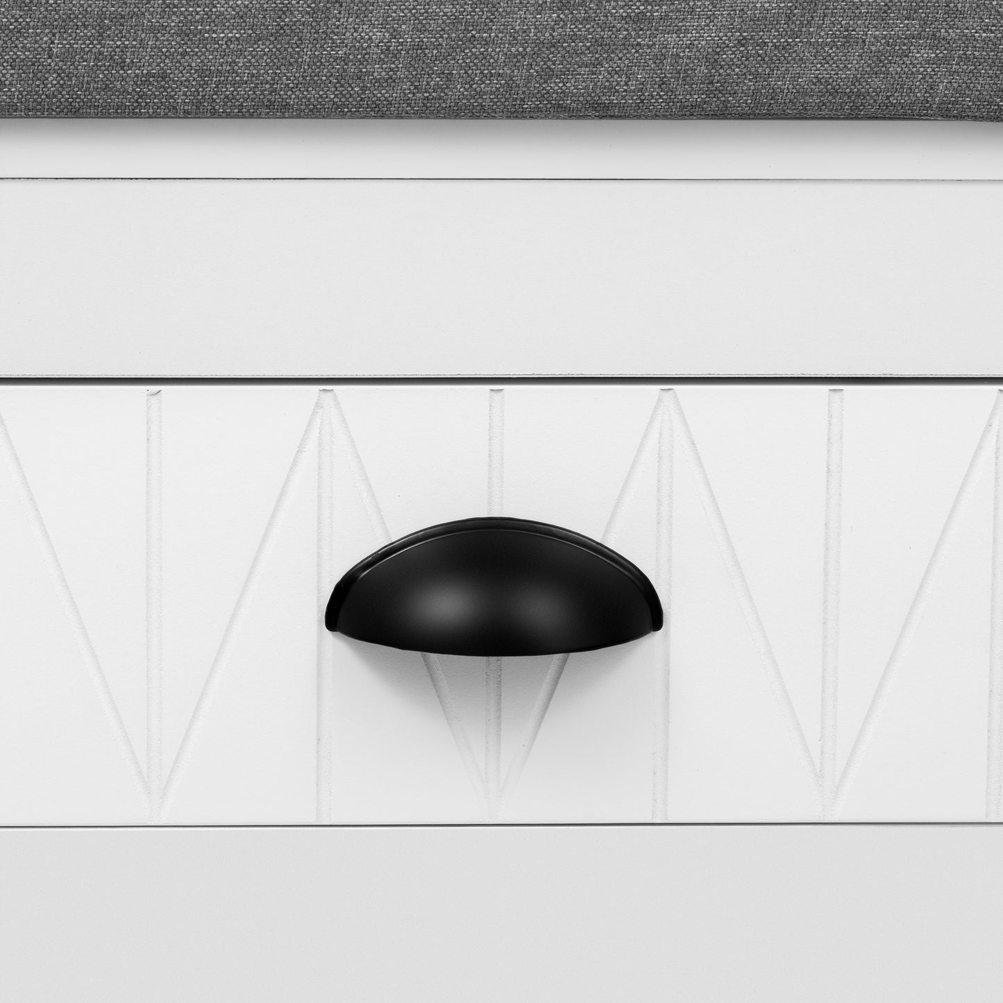 White dresser drawer with black cup pull and geometric panel detail