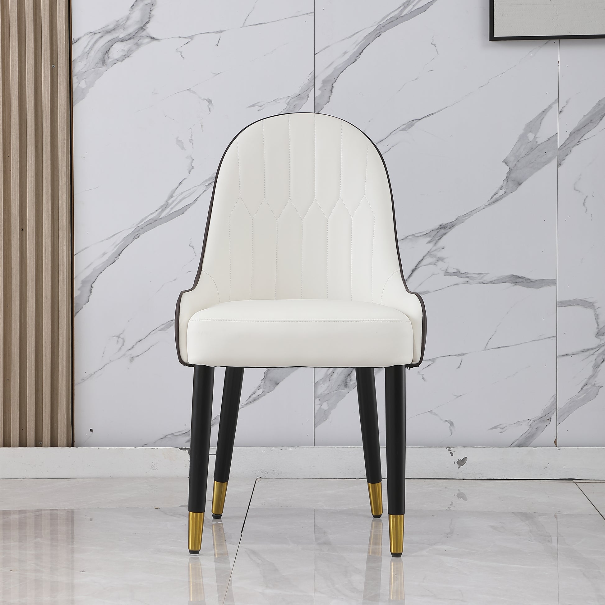 White upholstered dining chair with black legs and gold accents