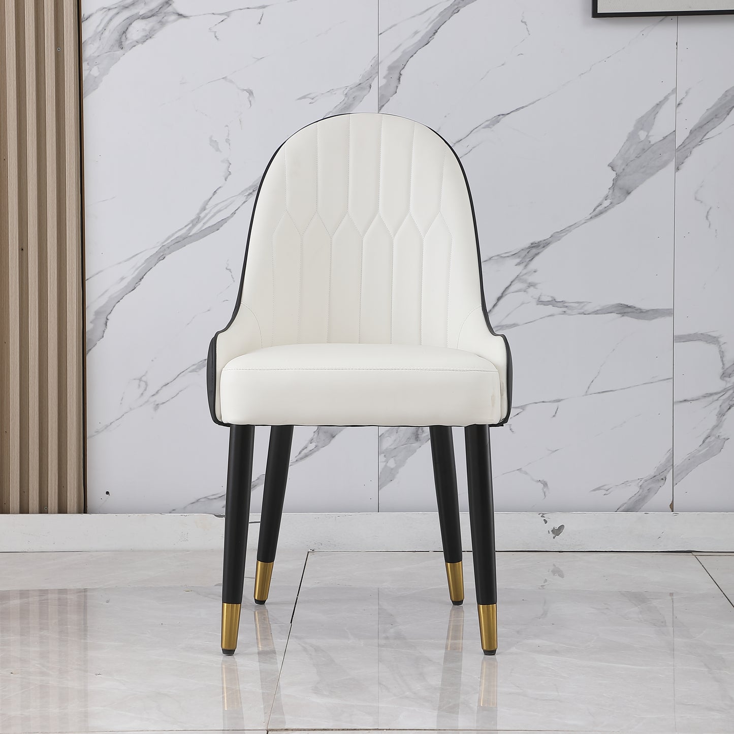 White upholstered dining chair with tufted seat and black metal legs with gold accents