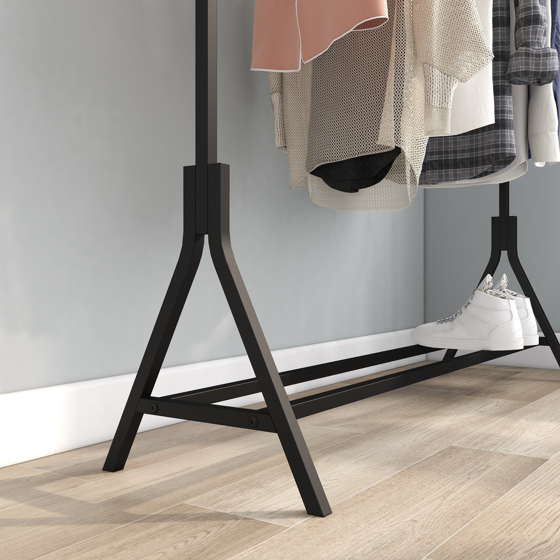 Black metal garment rack with clothes and white sneakers