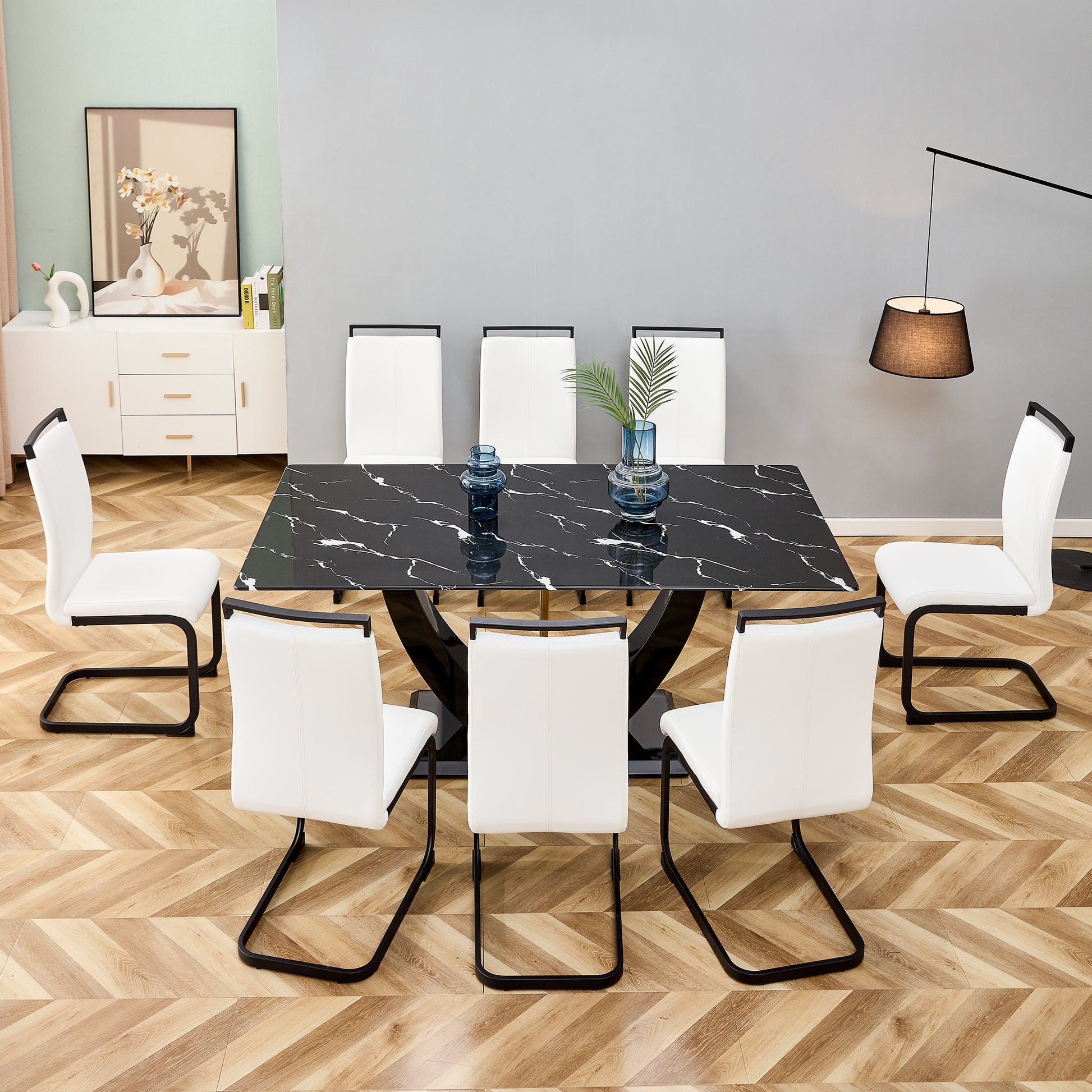 Black marble dining table with  white upholstered chairs