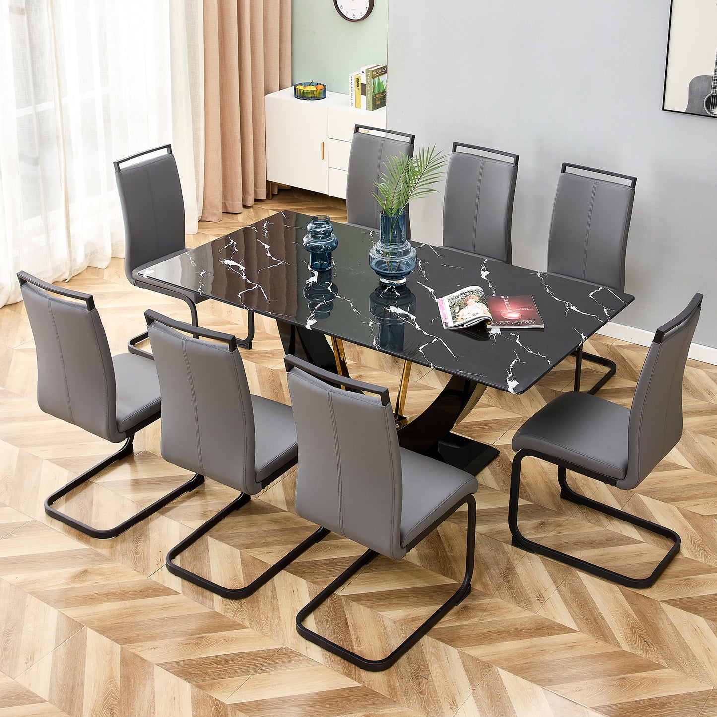 Modern black marble dining table with eight grey faux leather cantilever chairs