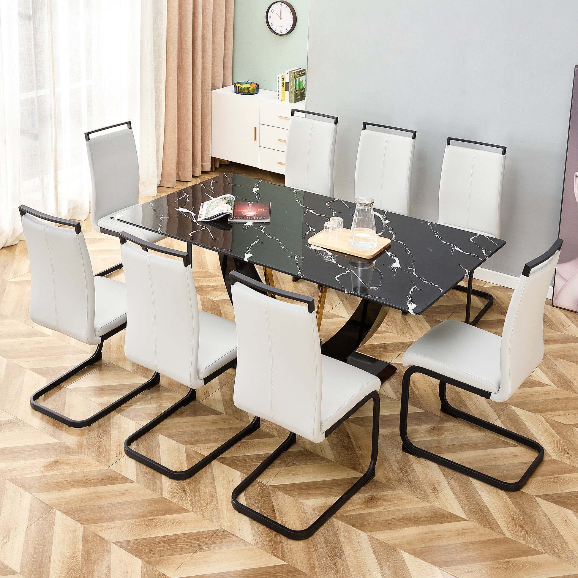 Black marble dining table with white faux leather chairs