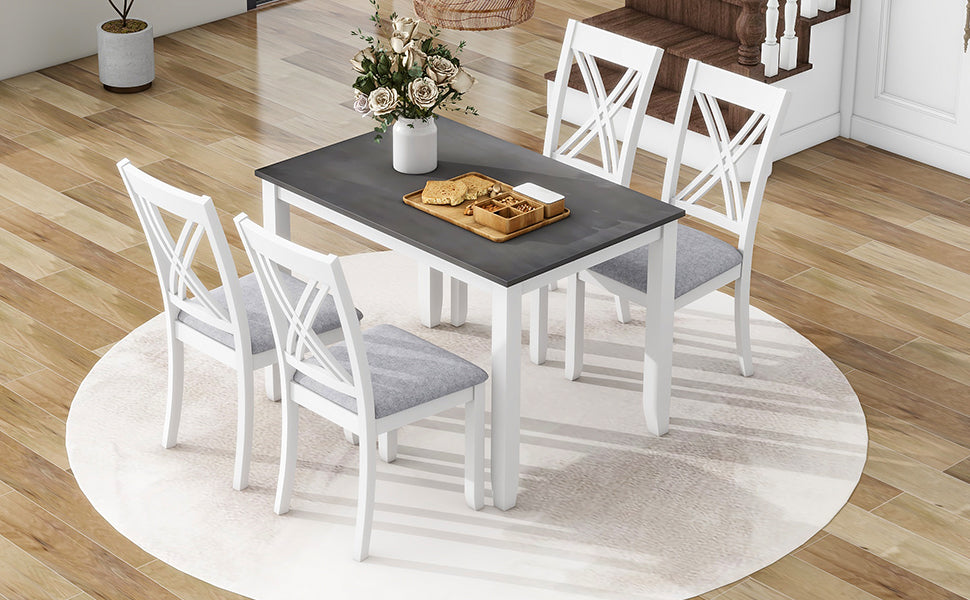 White dining table with gray tabletop and four upholstered chairs