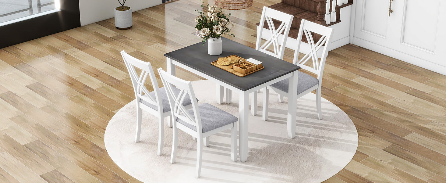 White wood dining set with dark gray tabletop and gray upholstered chairs
