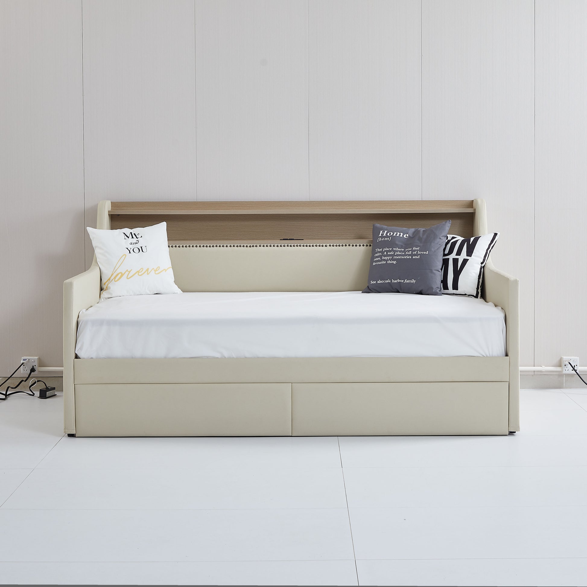 Cream upholstered daybed with storage drawers and wooden headboard shelf