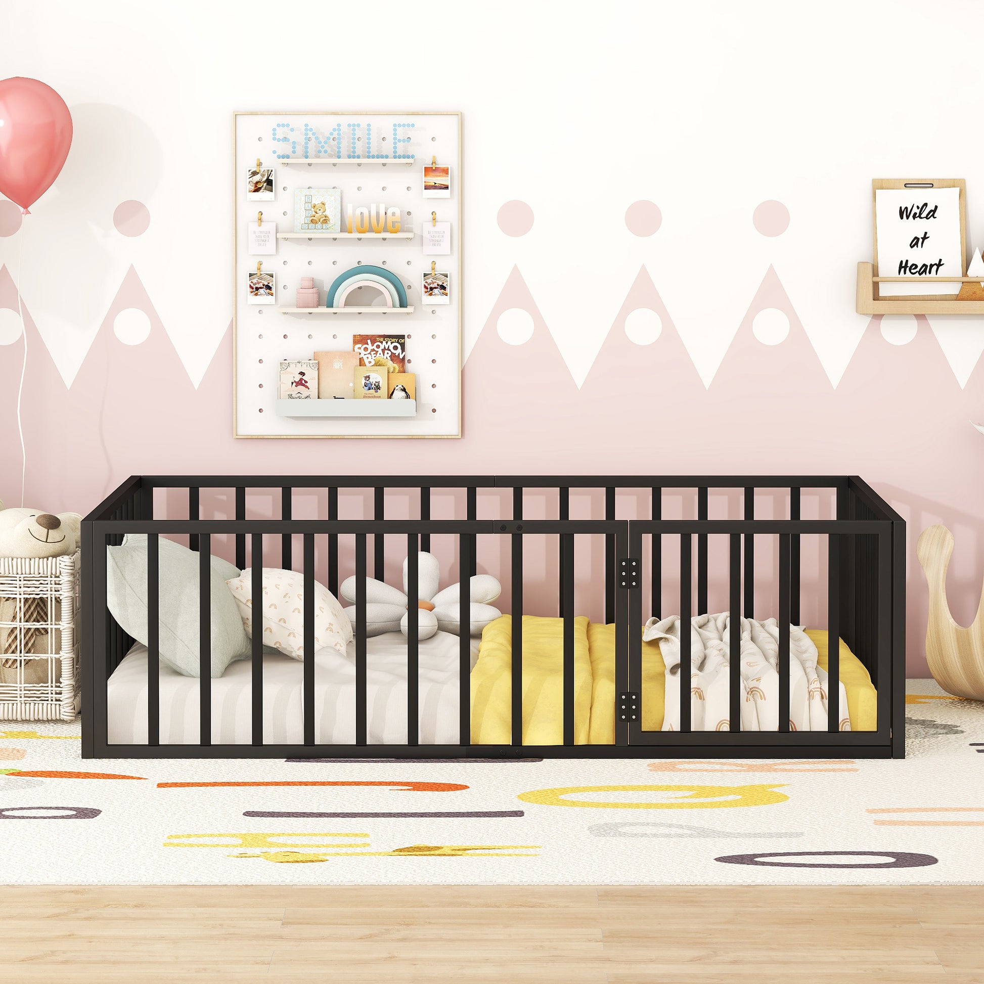 Black metal convertible crib with soft bedding and pillows