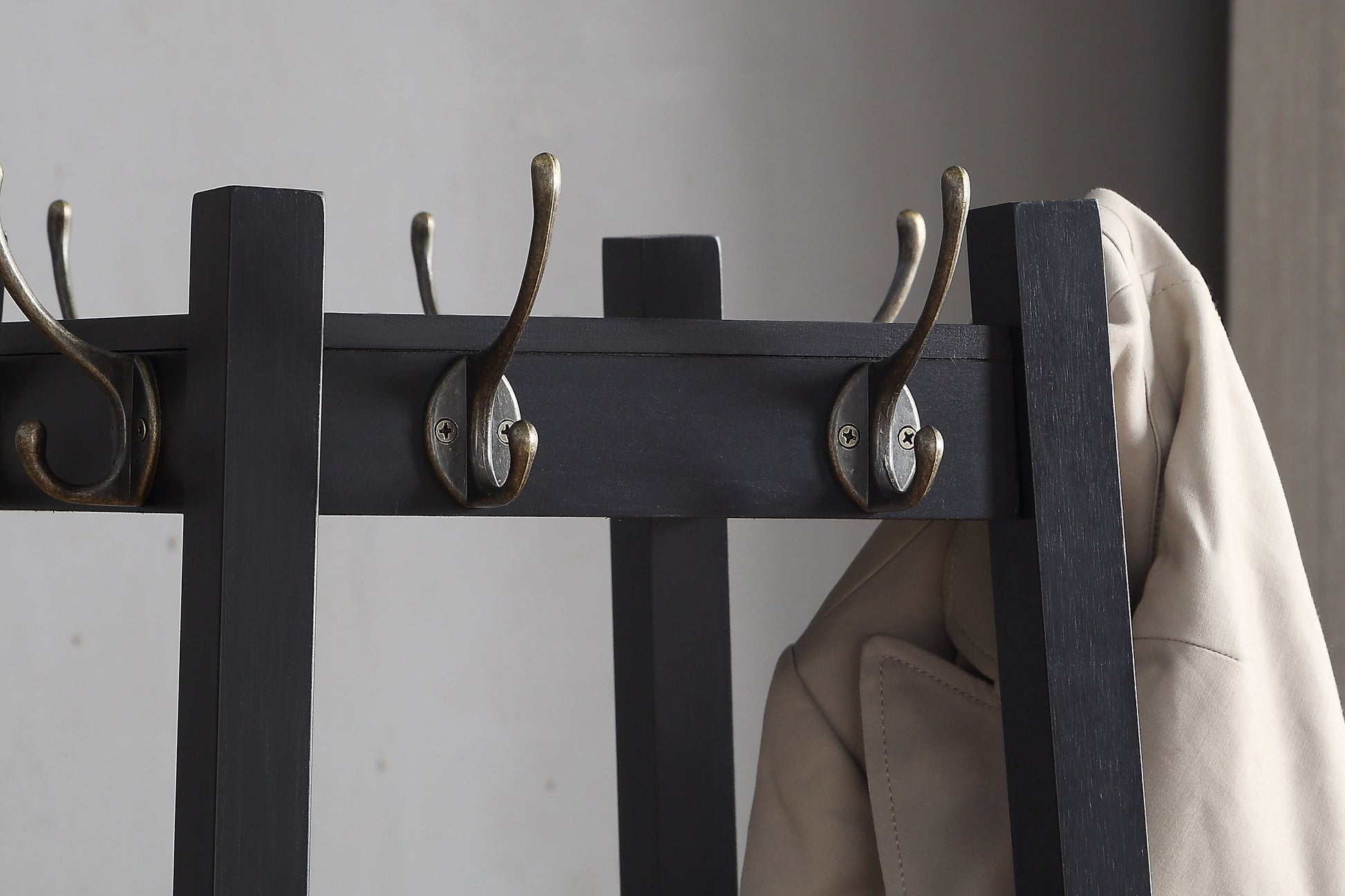 Dark gray wooden hall tree with antique brass hooks