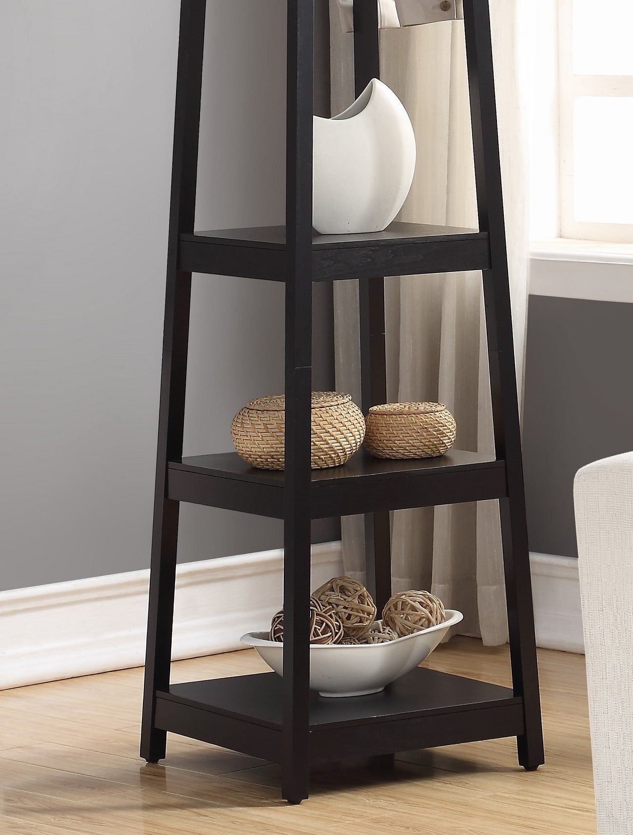 Black ladder shelf with white vase