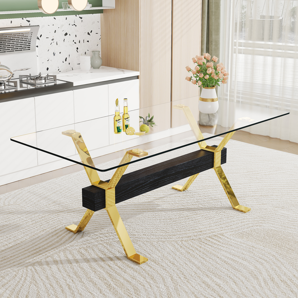Modern glass coffee table with gold Xframe legs and dark wood accent