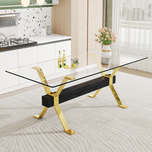 Modern glass coffee table with gold Xframe legs and dark wood accent