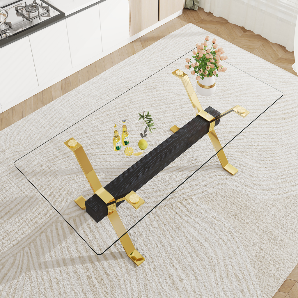 Modern glass coffee table with gold metal legs and dark wood accent