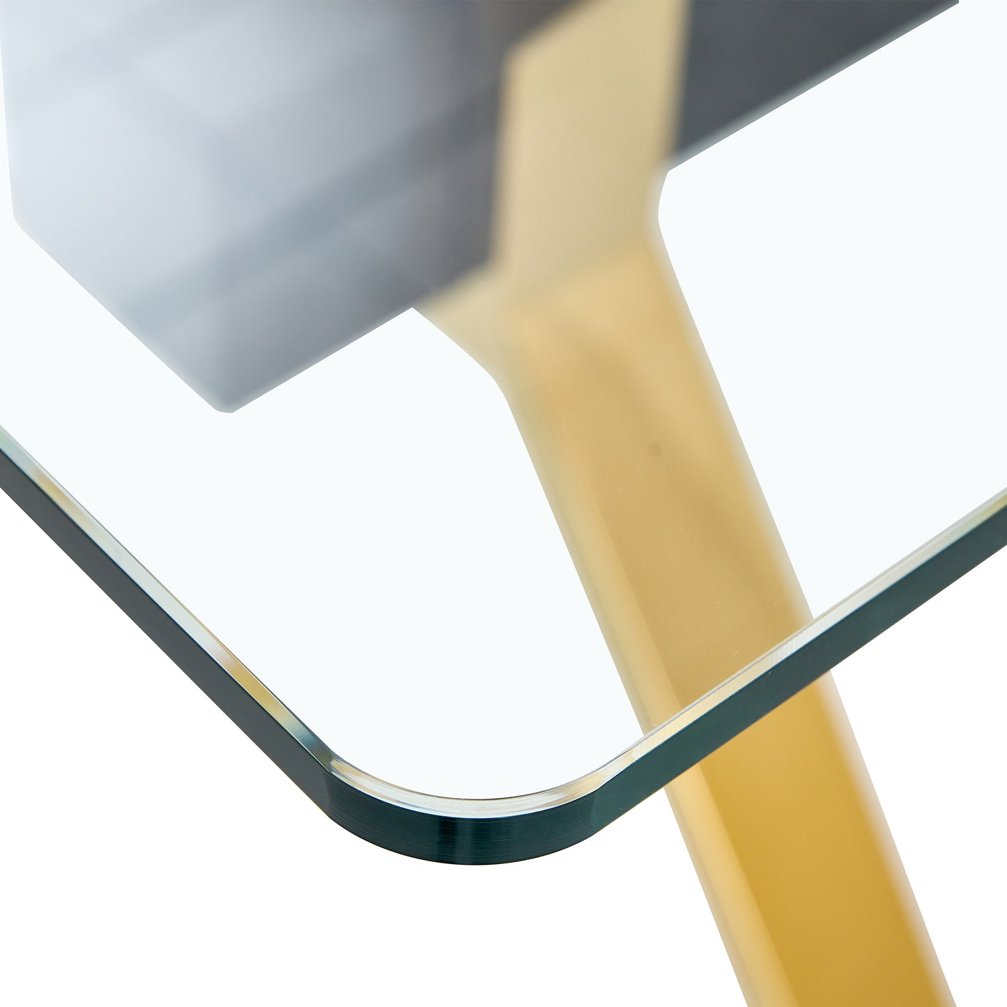 Closeup of a tempered glass tabletop with a gold metal leg