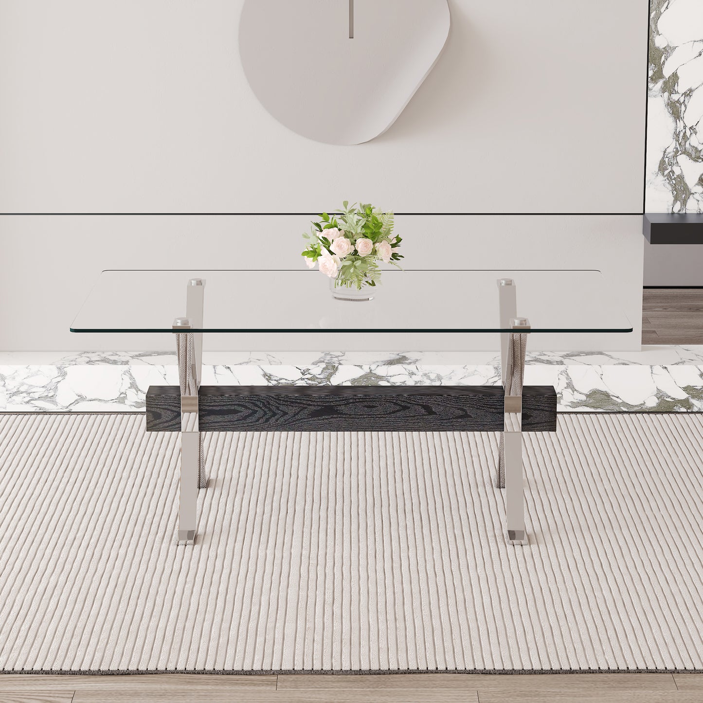 Sleek glass top coffee table with dark wood and chrome accents on a textured rug