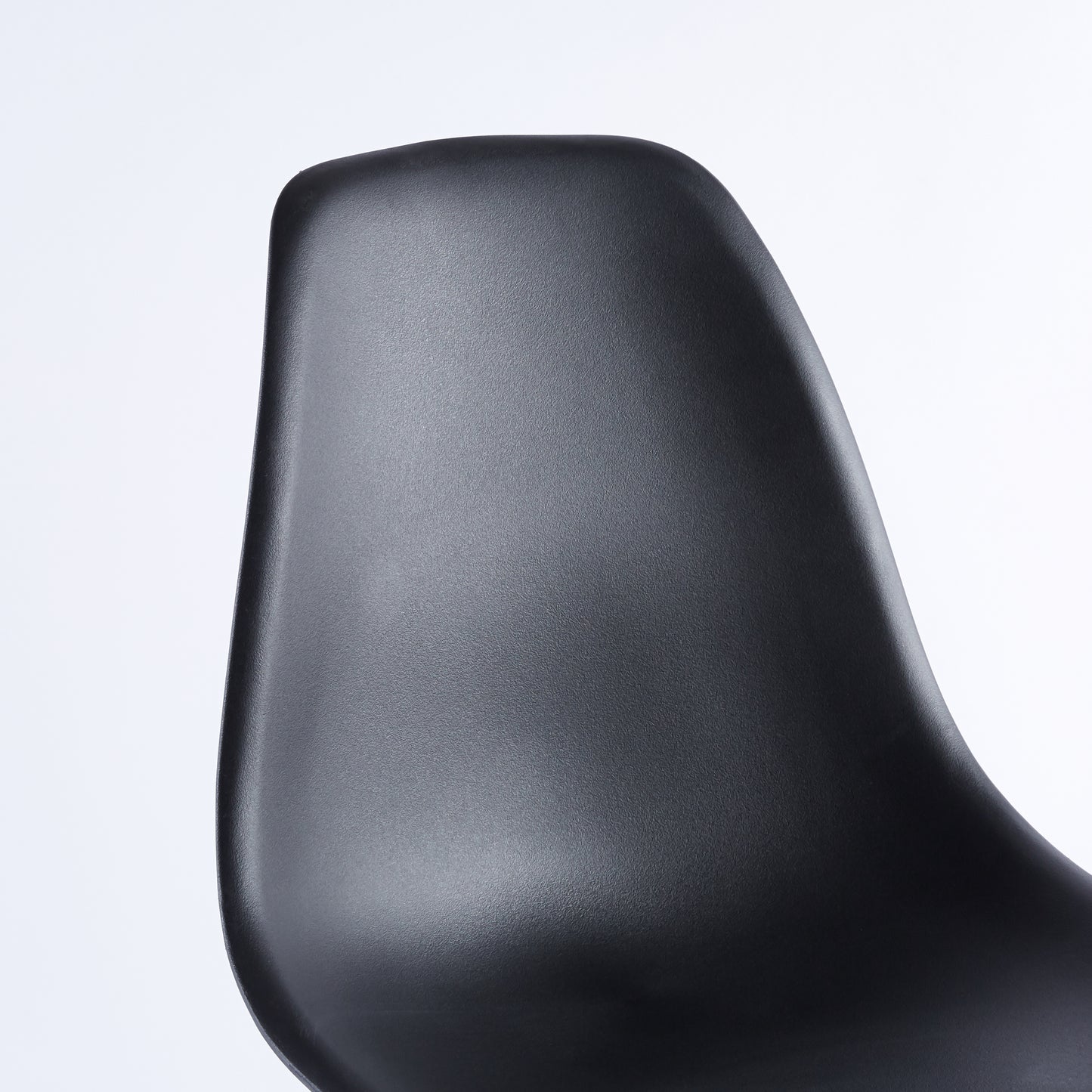 Black molded plastic chair back with textured finish