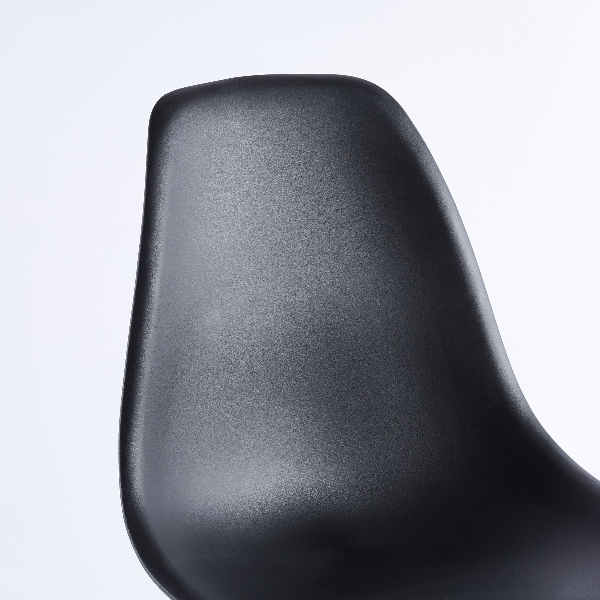 Black molded plastic chair back with textured finish